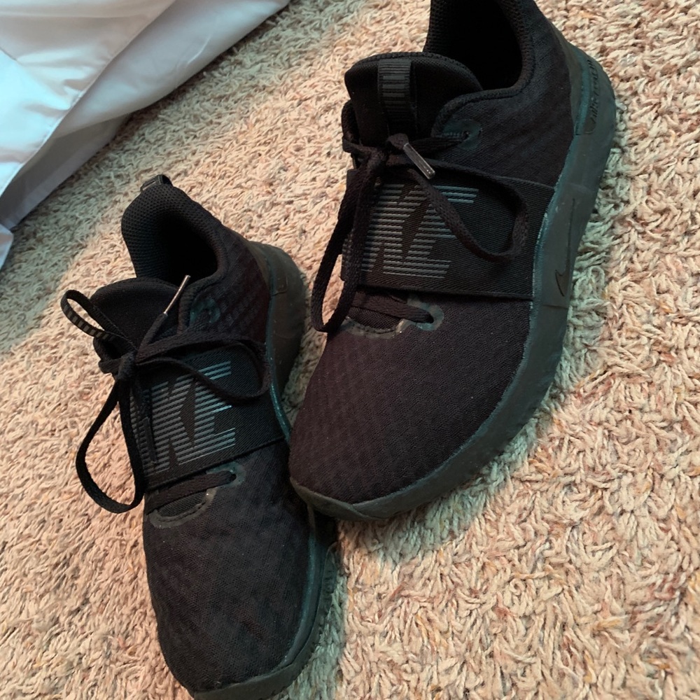 All black Nike Renew tennis shoes